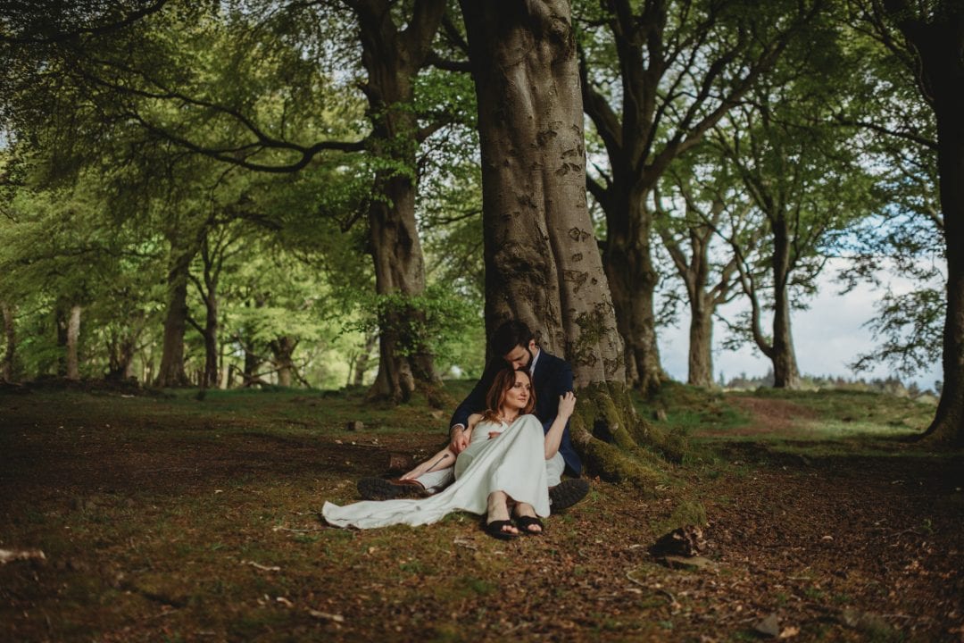 Adventure session in nature Scotland by trees. Lena Sabala and Patrick Zaarour on Mark Pacura workshop.