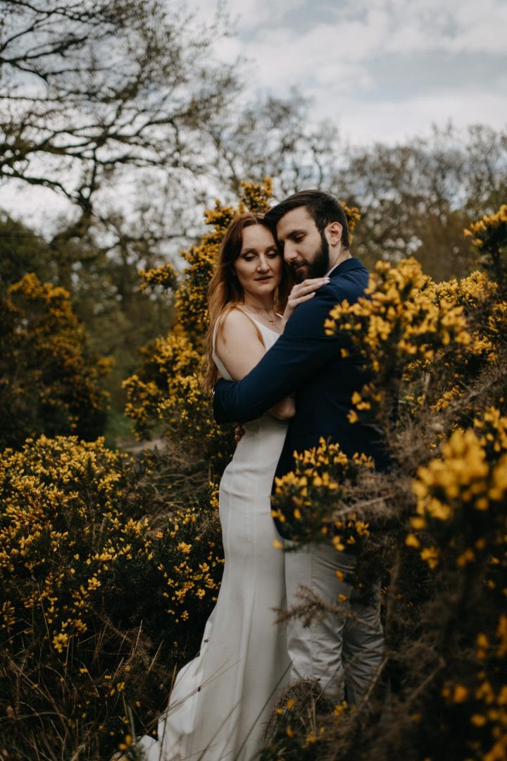 Couples shoot in nature Scotland by yellow gorse bush. Lena Sabala and Patrick Zaarour on Mark Pacura workshop.