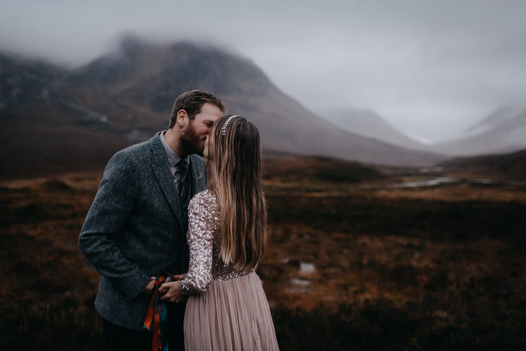 Handfasting ceremony in Glencoe Scotland - kissing couple