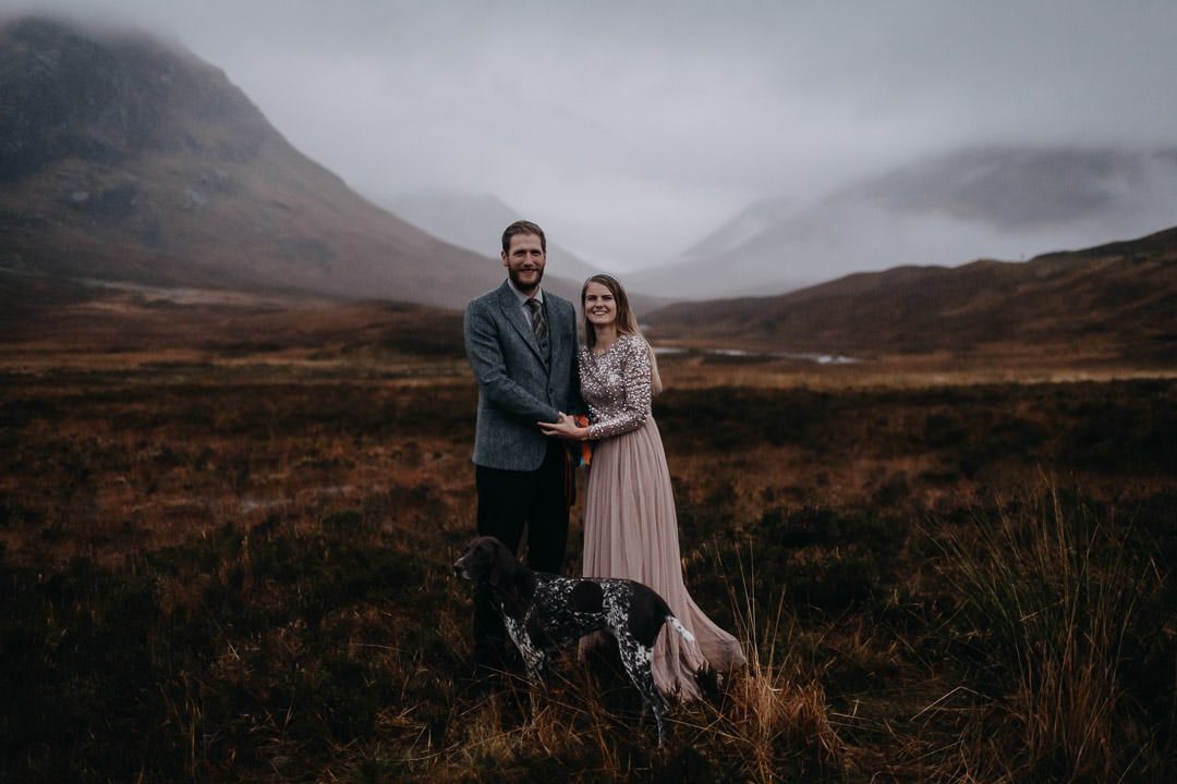 Happy handfasted couple in foogy Glencoe with dog