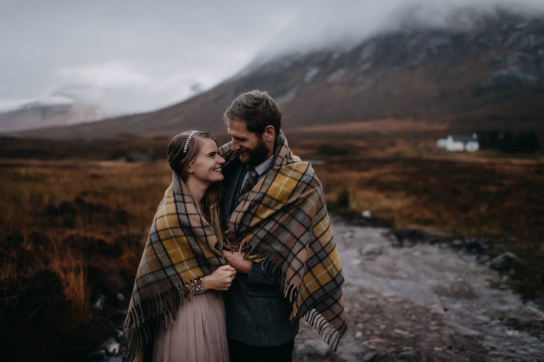 Happy elopement couple in Glencoe - tartan blanket