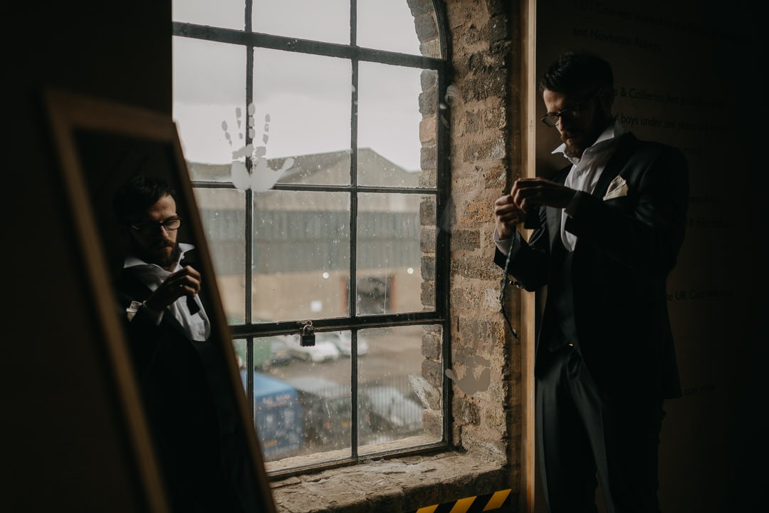Reflecting groom preparing to elope in Scotland - National Mining Museum
