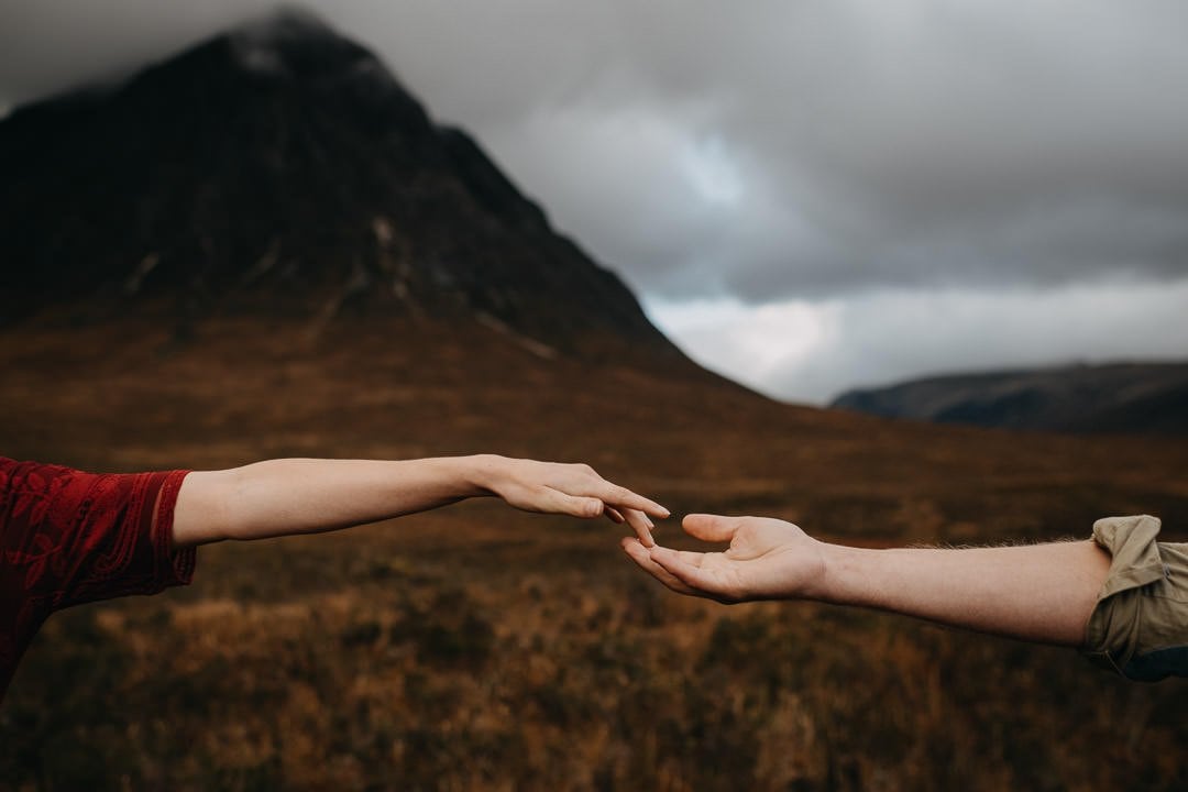 Fine art photo in the Scottish Highlands Buachaille Etive Mòr of couples hands during an elopement