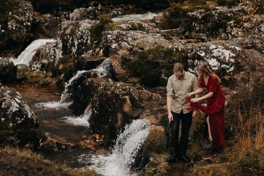 Adventure photoshoot with an engaged couple by Buachaille Etive Mòr in the Scottish Highlands - near waterfalls