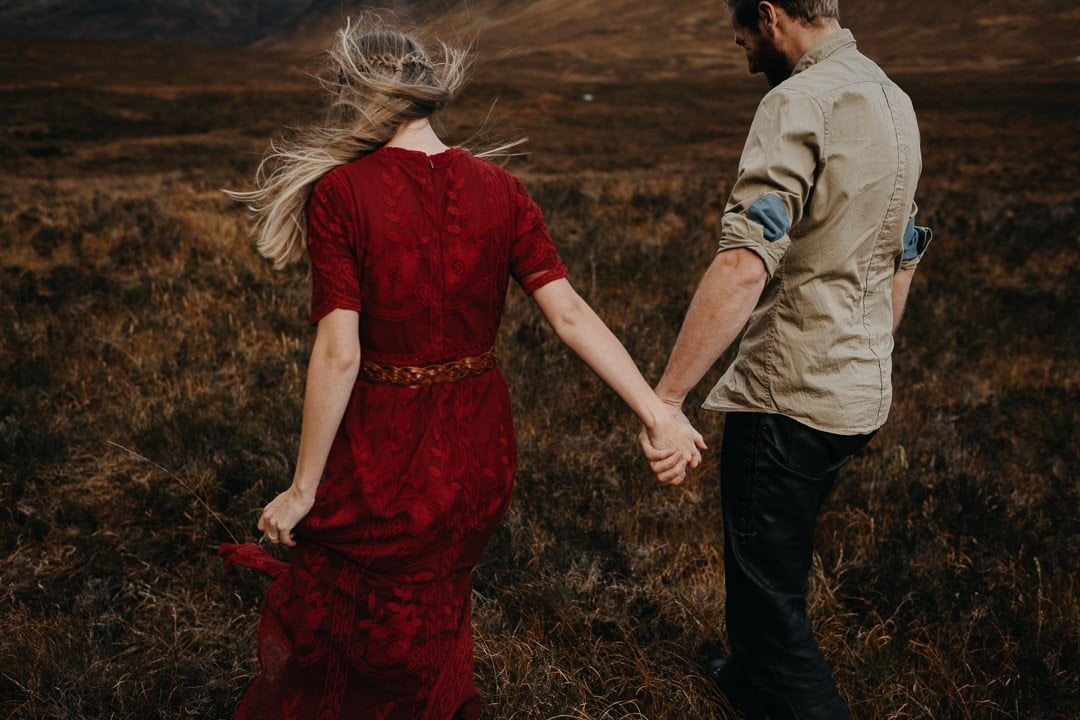 couple walking hand in hand during a romantic couples shoot in the Scottish Highlands, Glencoe