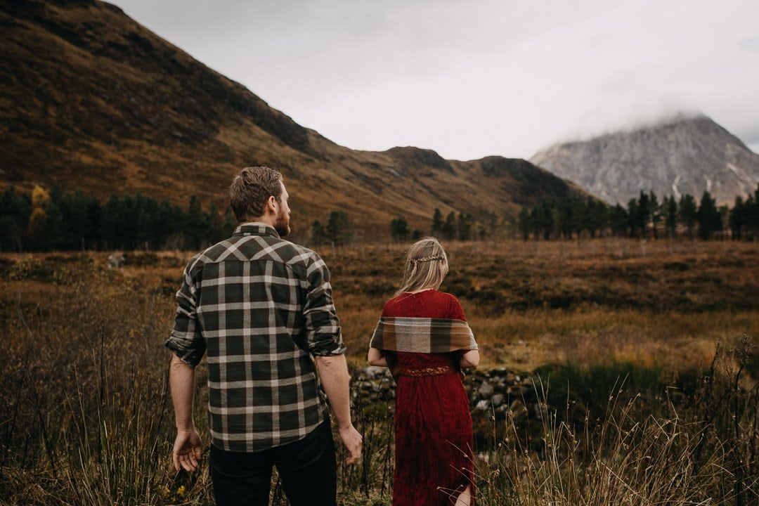 Elopement couple walking through the glens of Scotland - bohemian styled