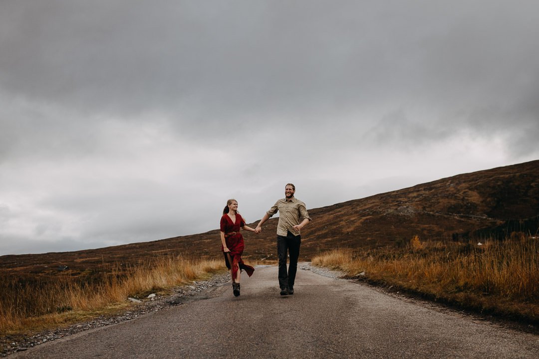 Couple running through Glen Etive during couples session