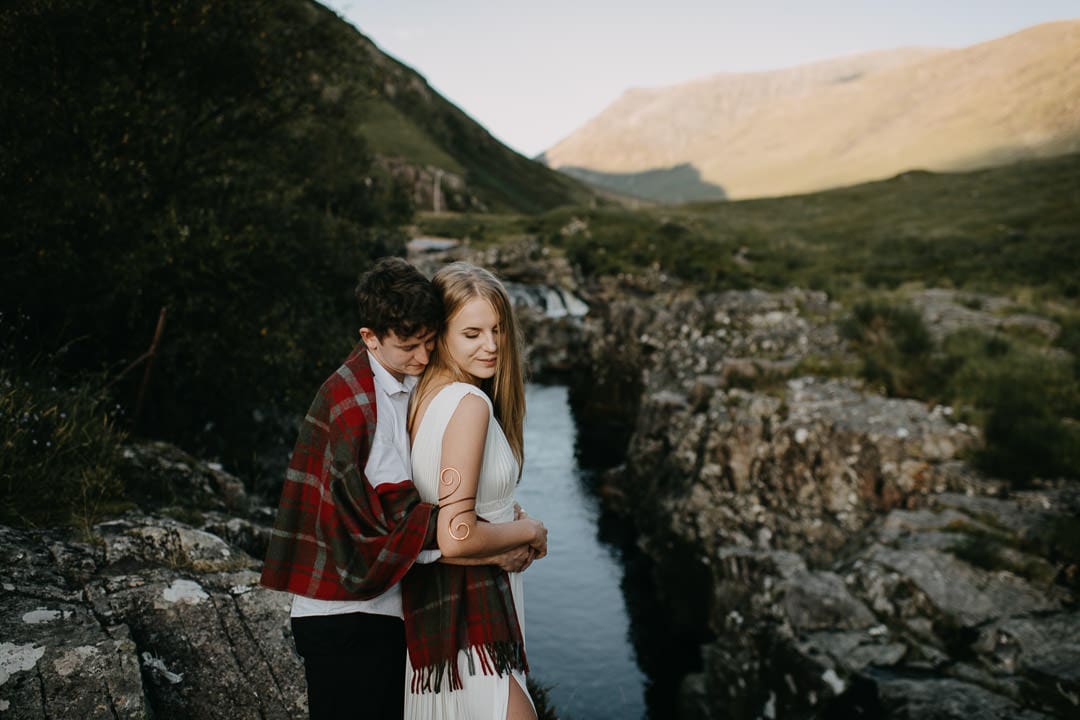 Wedding couple wrapped in a Tartan Blanket Co blanket during Glen Etive elopement