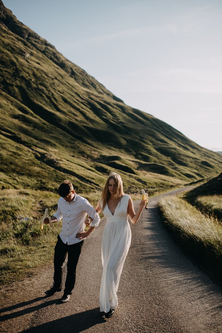 joyful eloping couple walking in Glen Etive