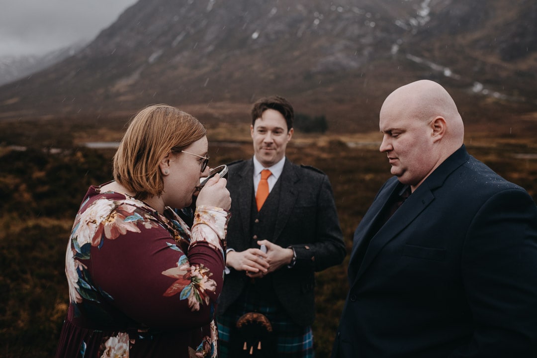 Drinking from quaich for handfasting ceremony during Glencoe adventure elopement