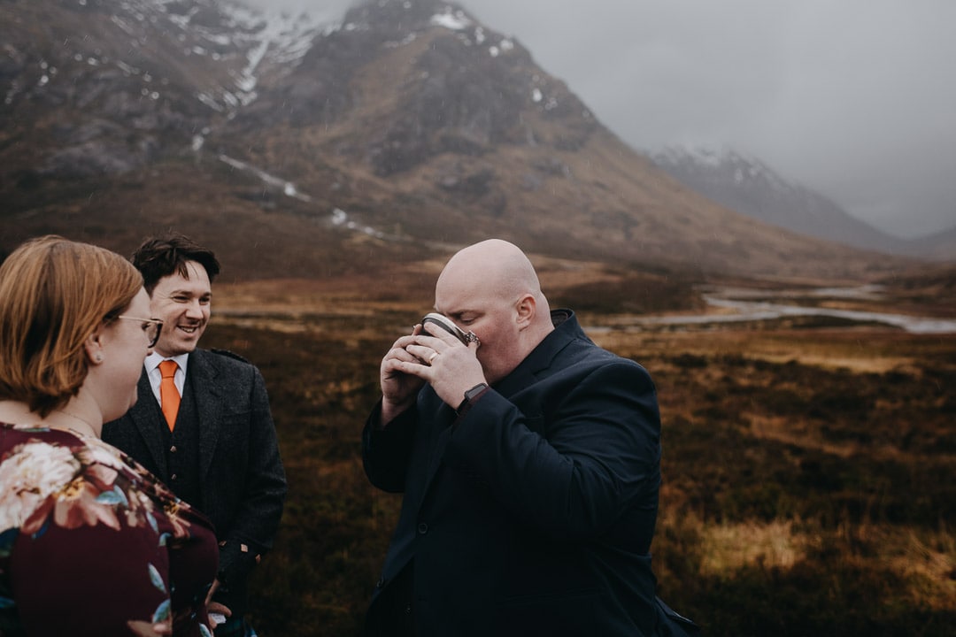 Drinking from quaich for handfasting ceremony during Glencoe adventure elopement