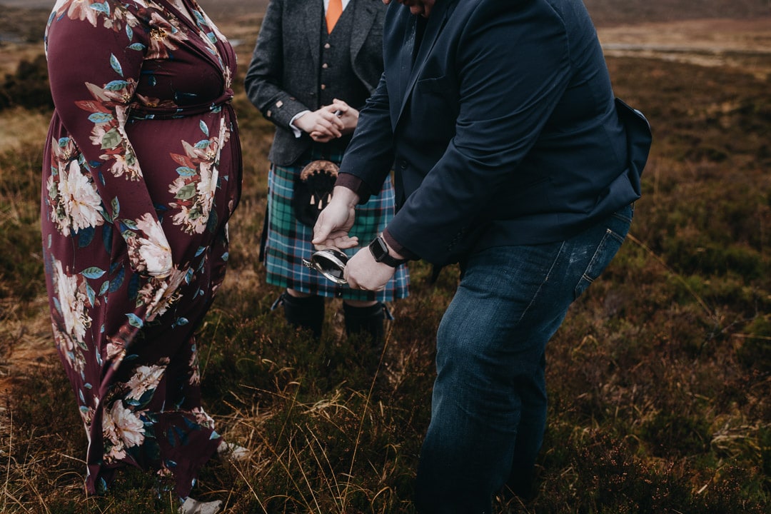 Drinking from quaich for handfasting ceremony during Glencoe adventure elopement