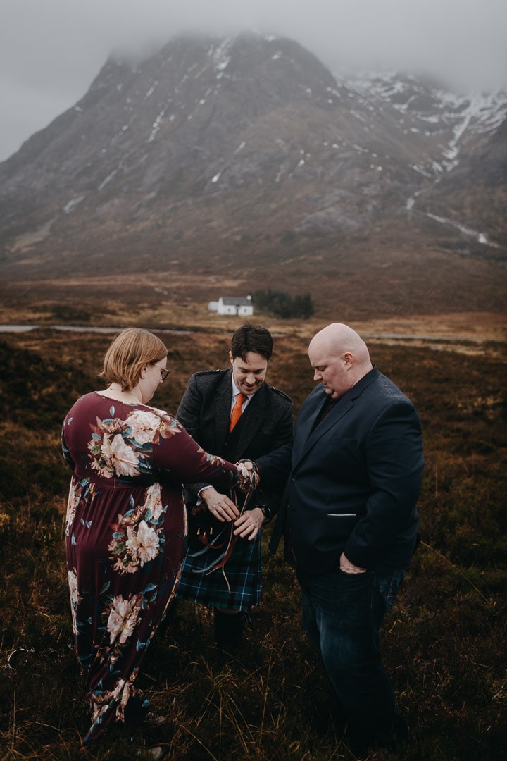 Romantic handfasting in Glencoe during wedding anniversary photoshoot in Scottish Highlands