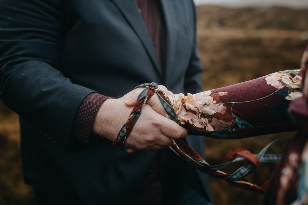 Romantic handfasting cord in Glencoe during wedding anniversary photoshoot in Scottish Highlands
