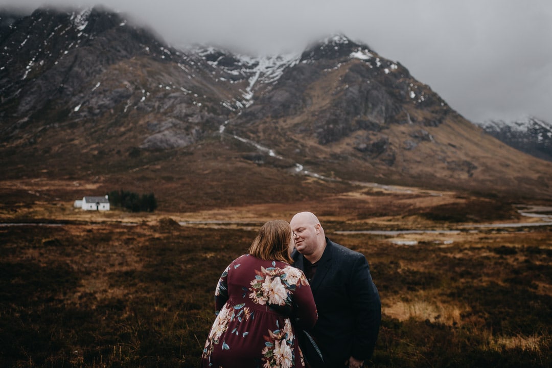 Romantic handfasting in Glencoe during wedding anniversary photoshoot in Scottish Highlands