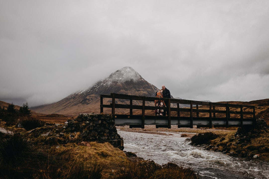 Exploring Buachaille Etive Mhor in Glencoe on couples adventure session wearing a tartan blanket