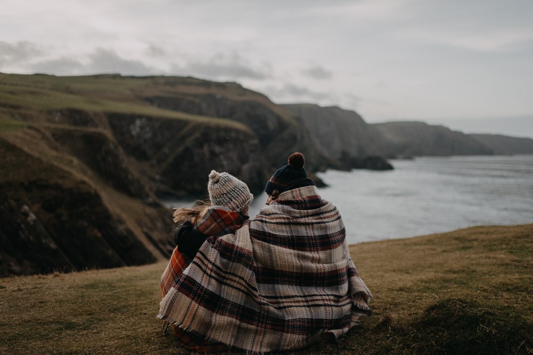 Proposal location in Scotland - cute couple cuddled up at St Abbs