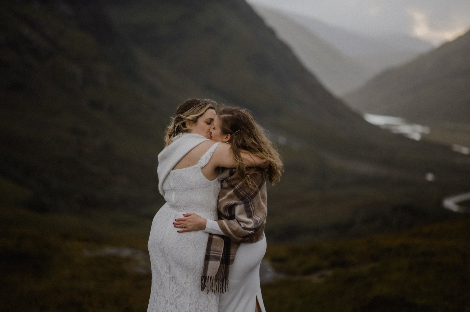 Glencoe elopement with stormy sunset - two brides kissing