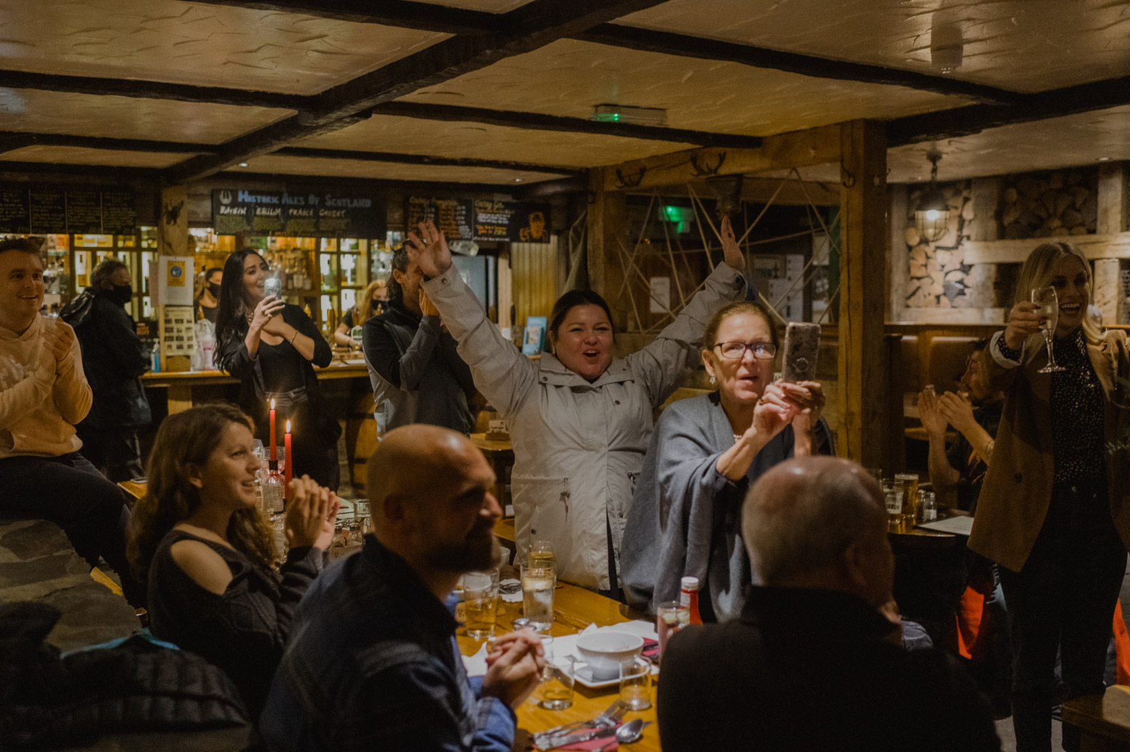 Friends and family welcoming same-sex couple to Clachaig Inn in Glencoe