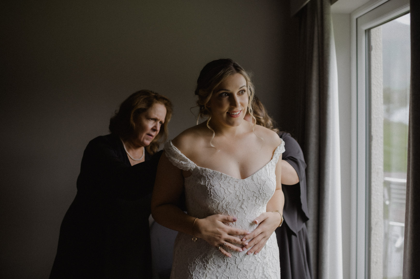 getting into dress for Scotland elopement