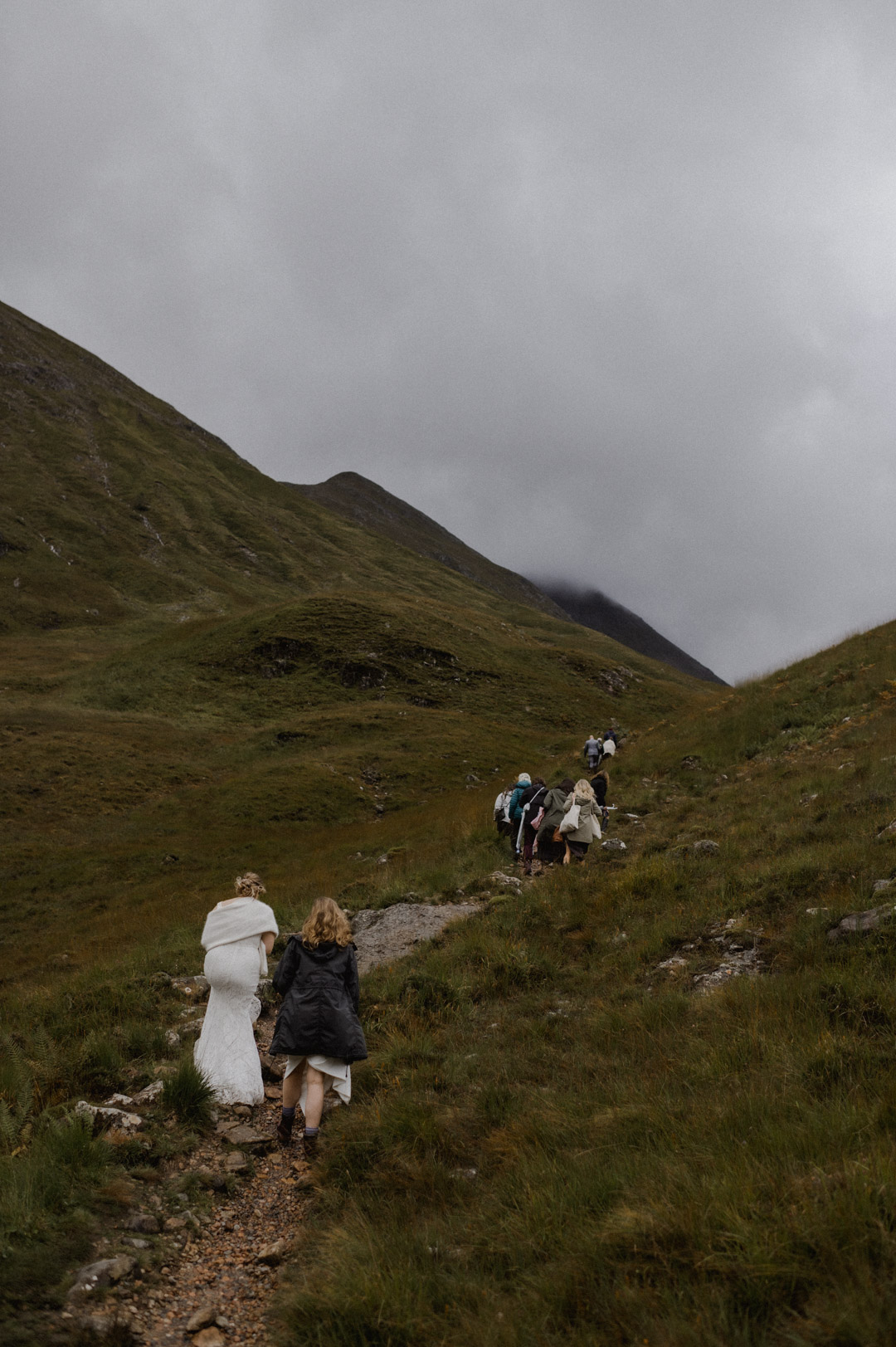 climbing hill to elopement ceremony in Glencoe, Scotland