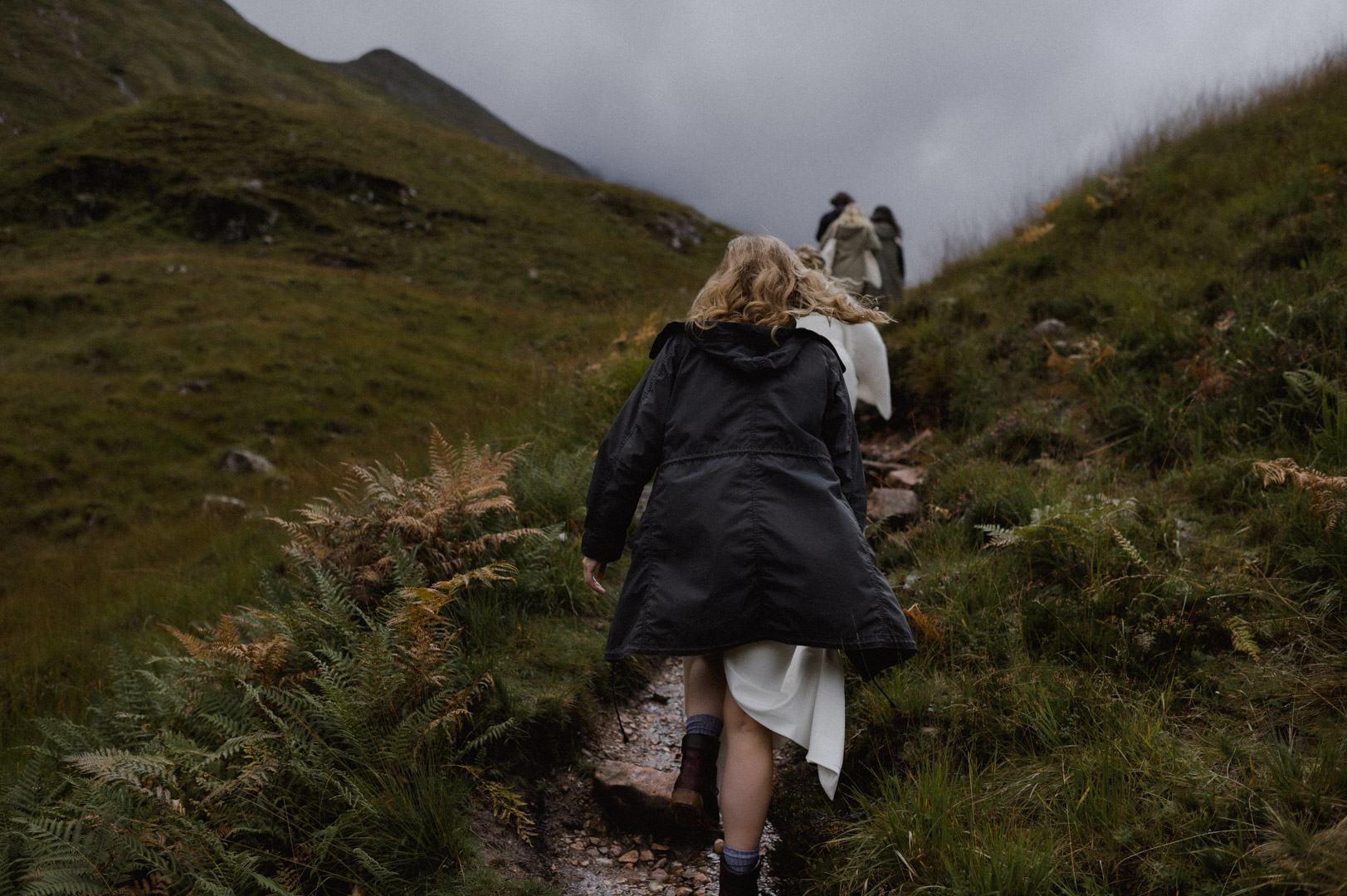 climbing hill to elopement ceremony in Glencoe, Scotland