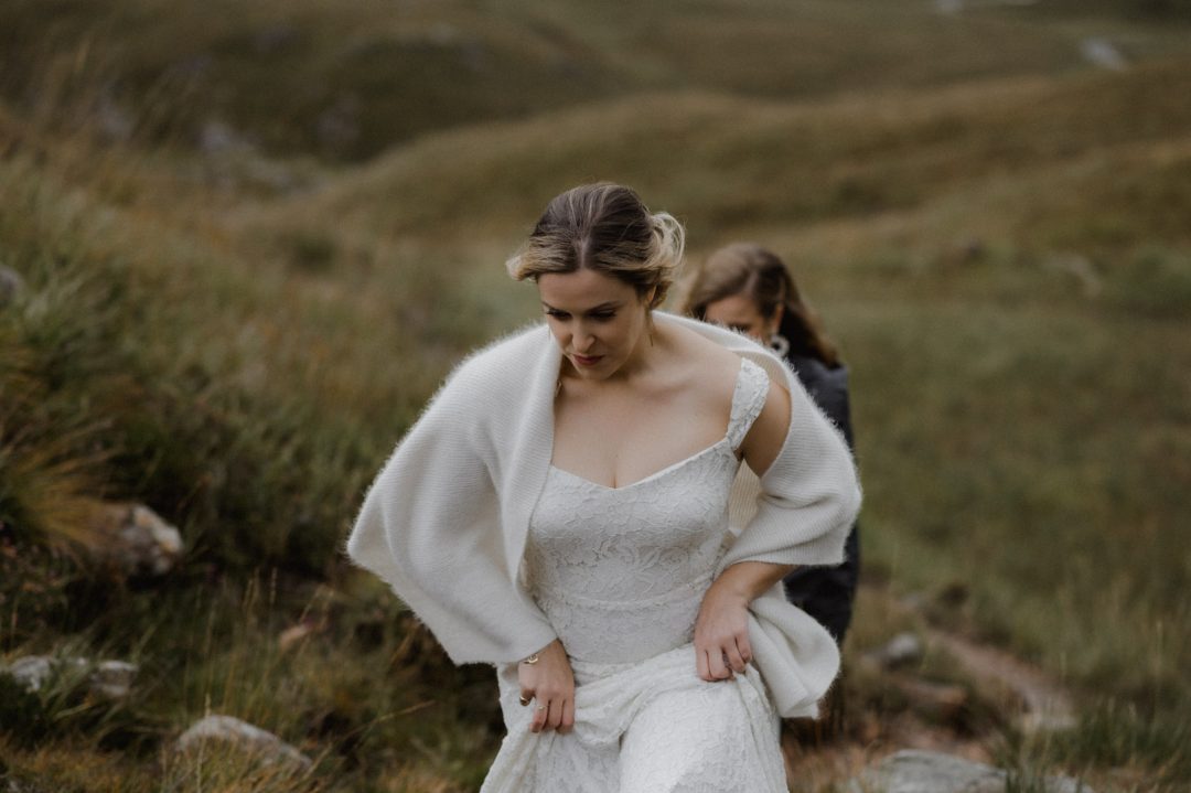climbing hill to elopement ceremony in Glencoe, Scotland
