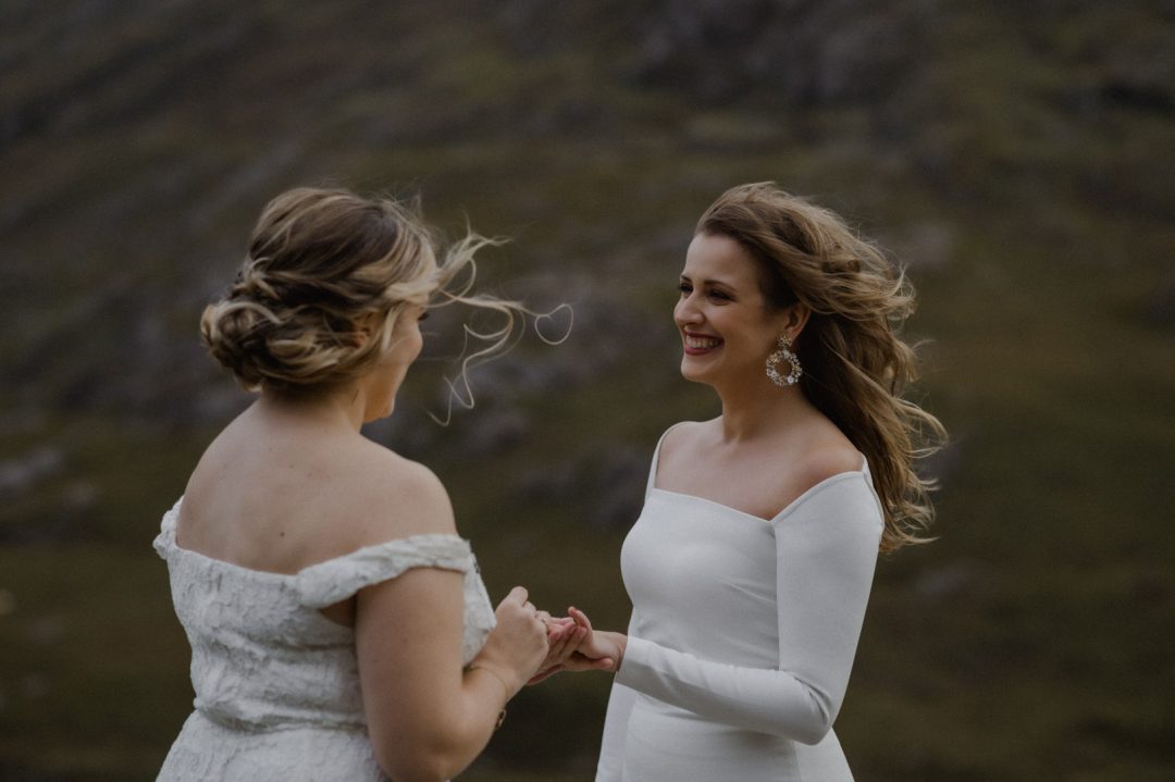 Ring exchange during LGBTQ+ elopement ceremony in Glencoe during storm
