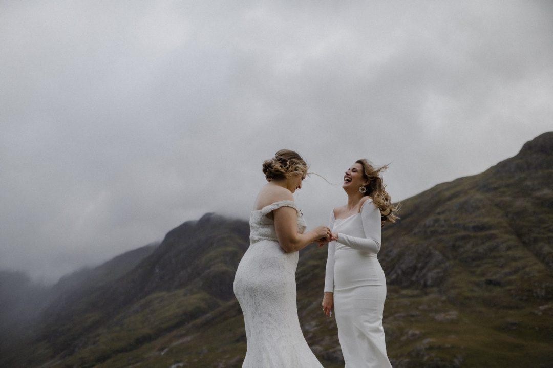 Ring exchange during LGBTQ+ elopement ceremony in Glencoe during storm