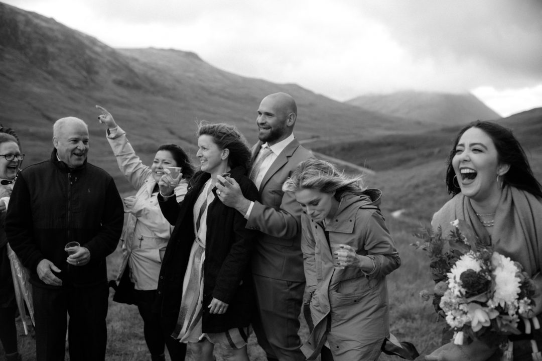 Family cheering on stormy elopement ceremony