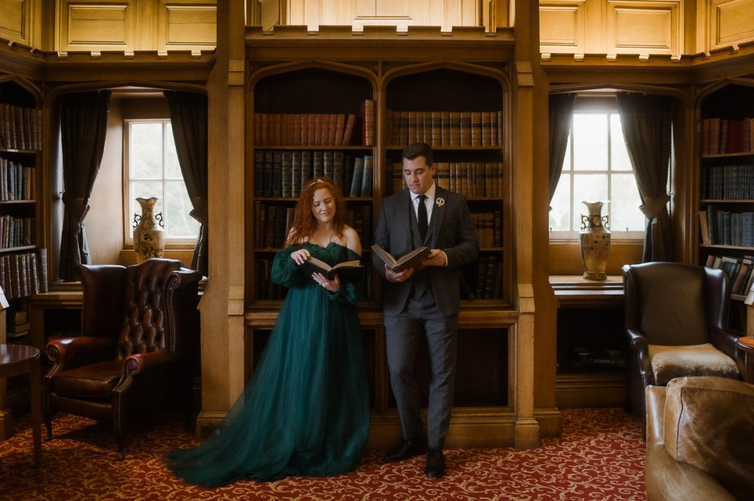 Elopement couple reading in an old Scottish castle library