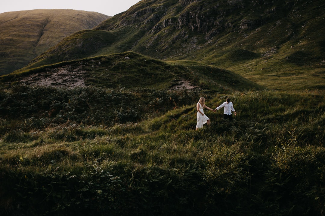 Eloping couple roaming the glen in the Scottish highlands