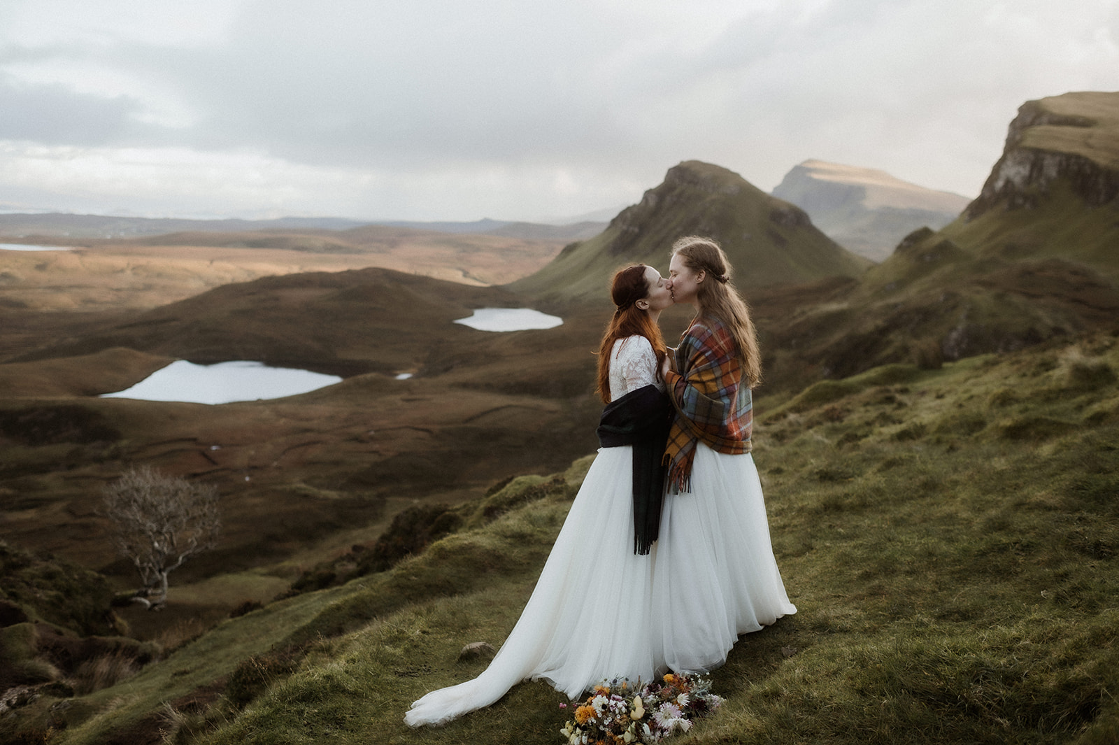 Two brides kiss after their vows at the Quiraing for their elopement on Isle of Skye