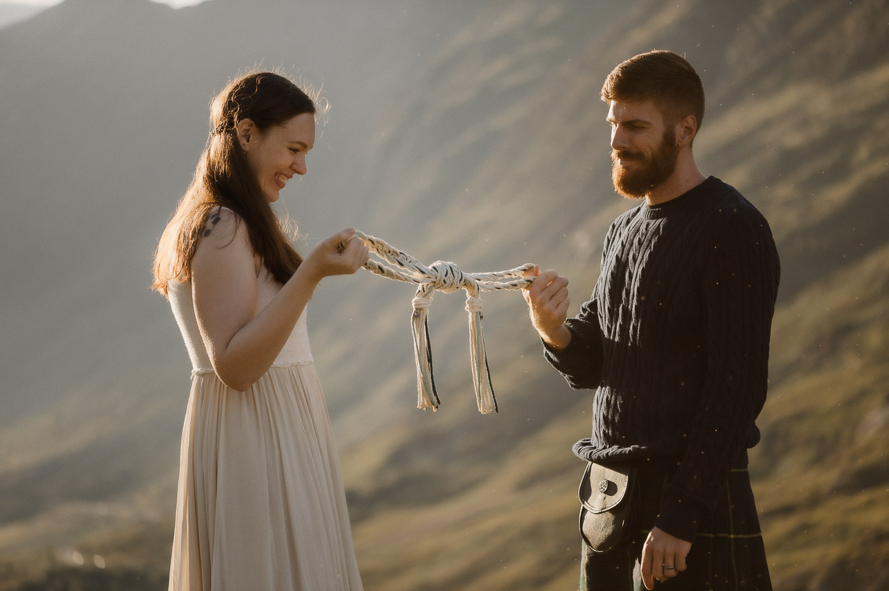 Couple being handfasted with midges during summer