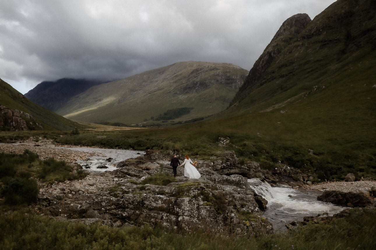 Couple eloping in Glen Etive during summer - small in landscape