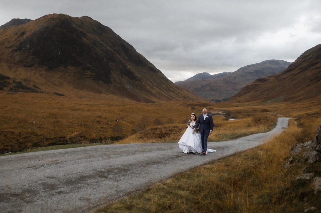 Glen etive elopement in Autumn - couple running along road