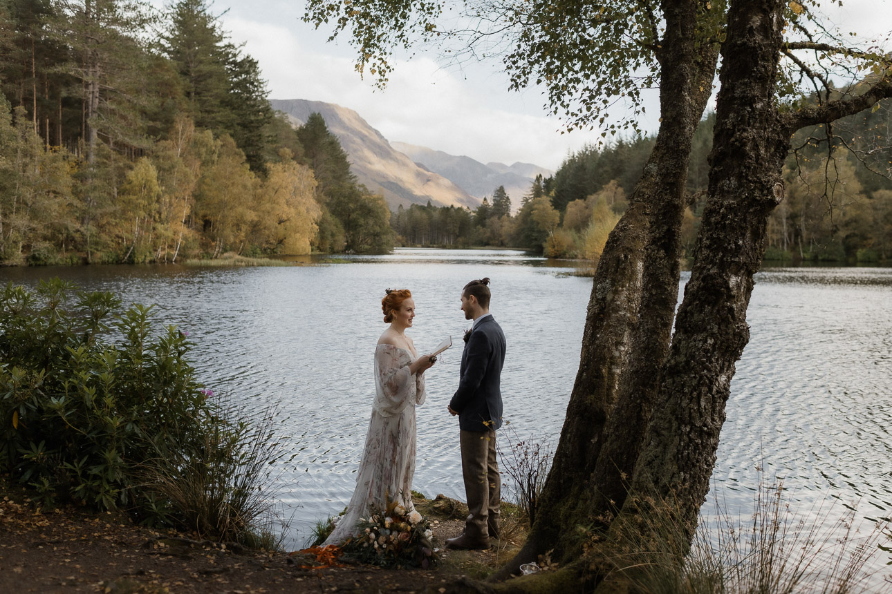 Glencoe lochan elopement ceremony in Autumn - couple reading vows